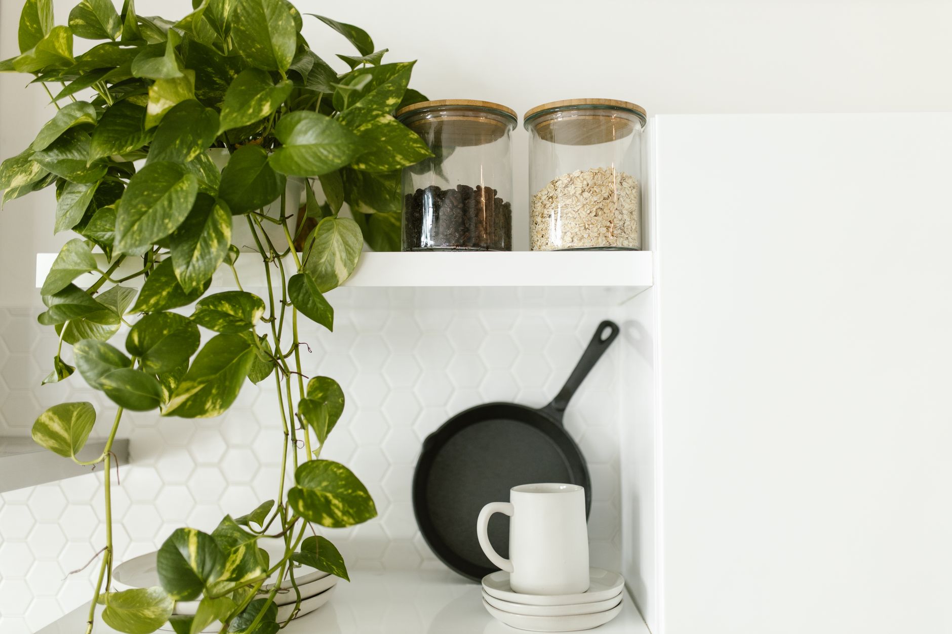 Amber glass canisters holding coffee beans on an open kitchen shelf