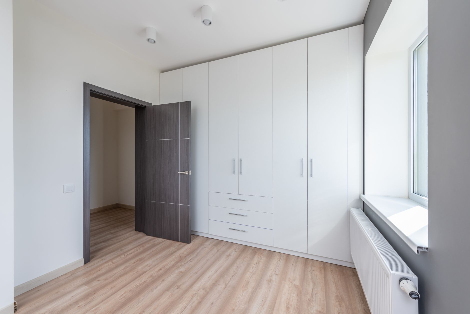 Tall armoire with both doors open revealing a coffee setup on an interior pull-out shelf