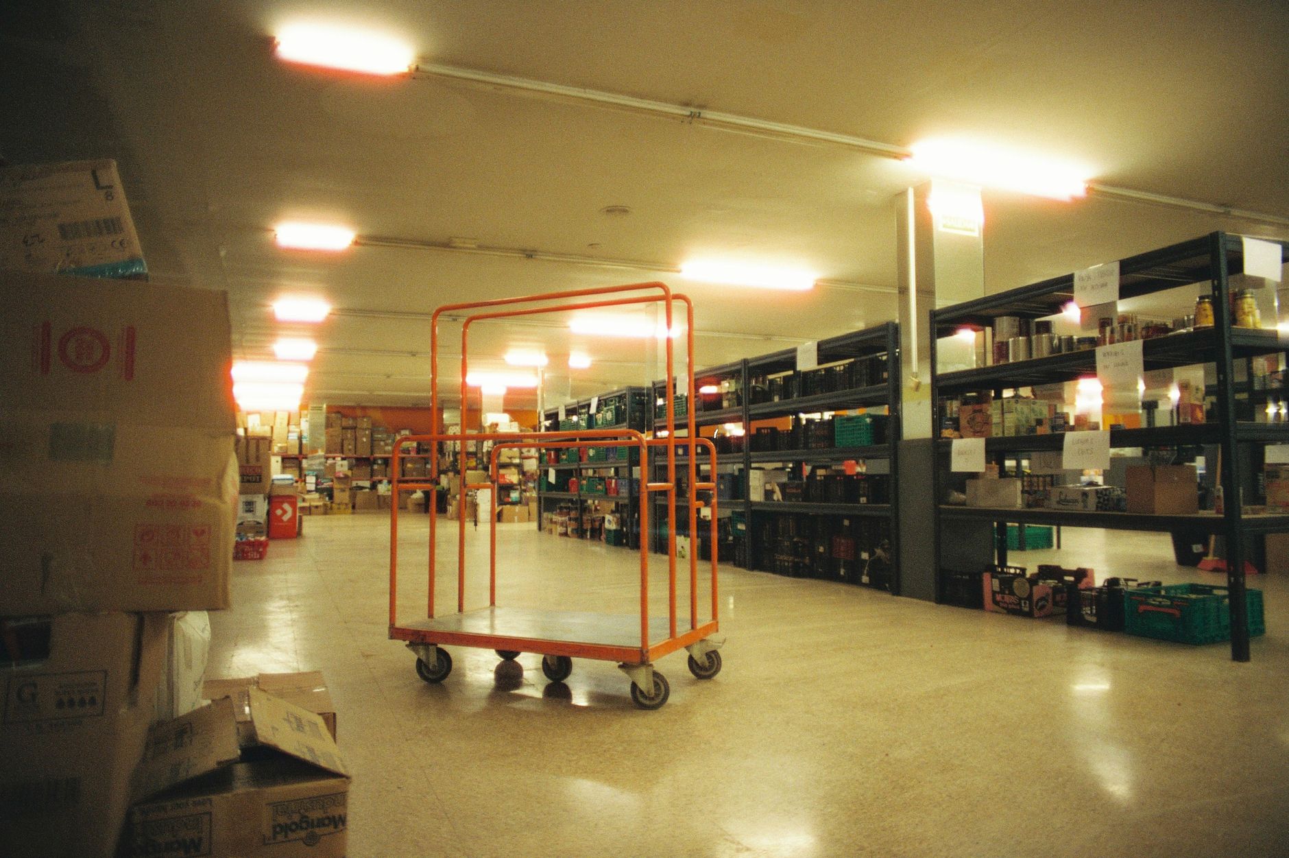 A rolling cart with each shelf holding a distinct group of coffee supplies