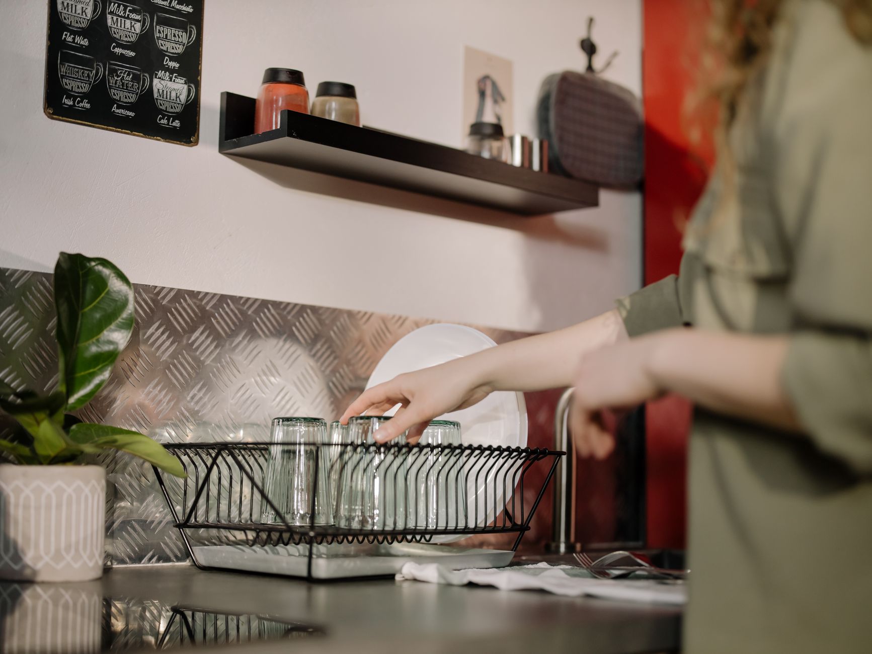 A narrow picture ledge mounted above a counter holding a small print and a bag of beans