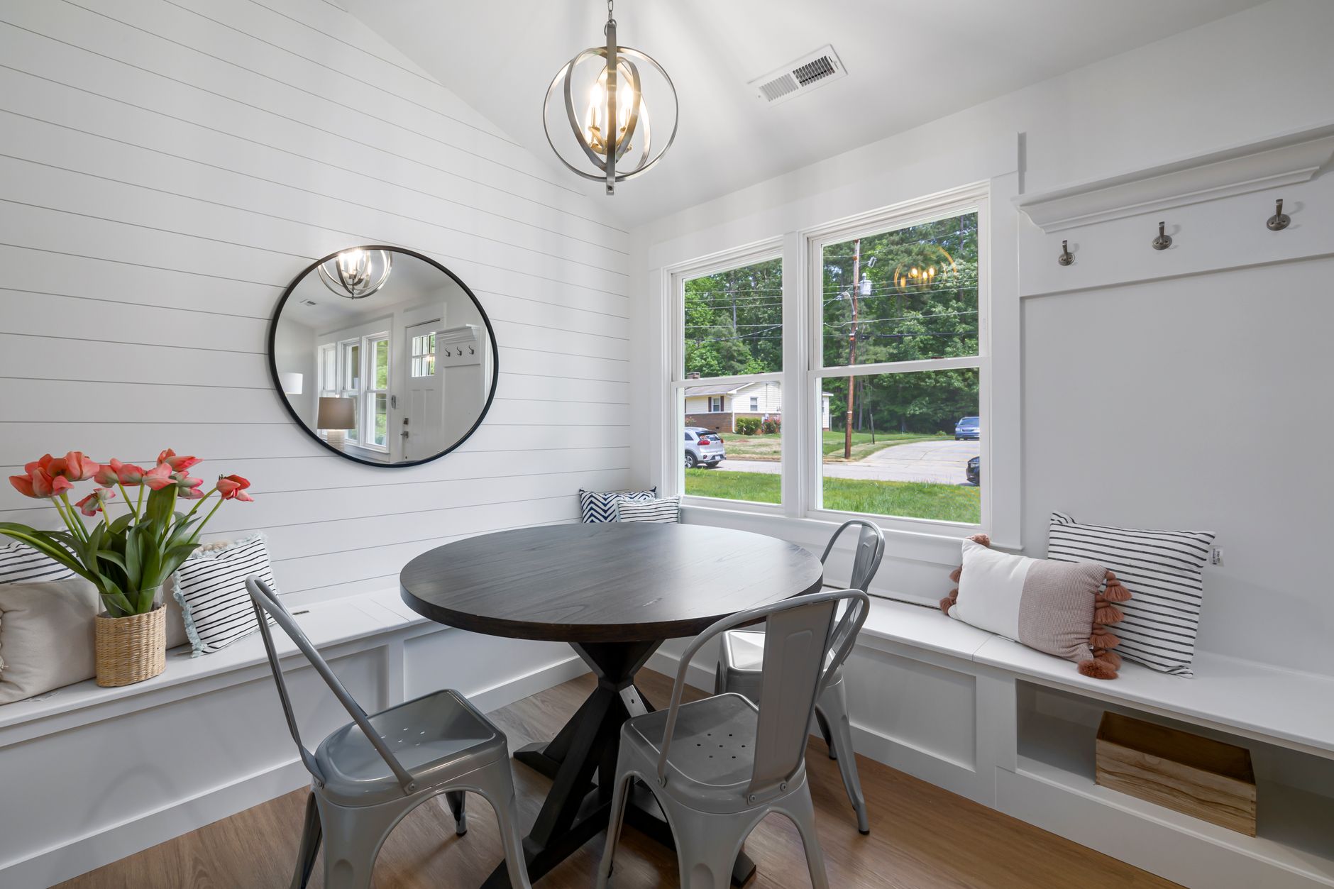 White shiplap panel behind a small kitchen counter with a coffee maker