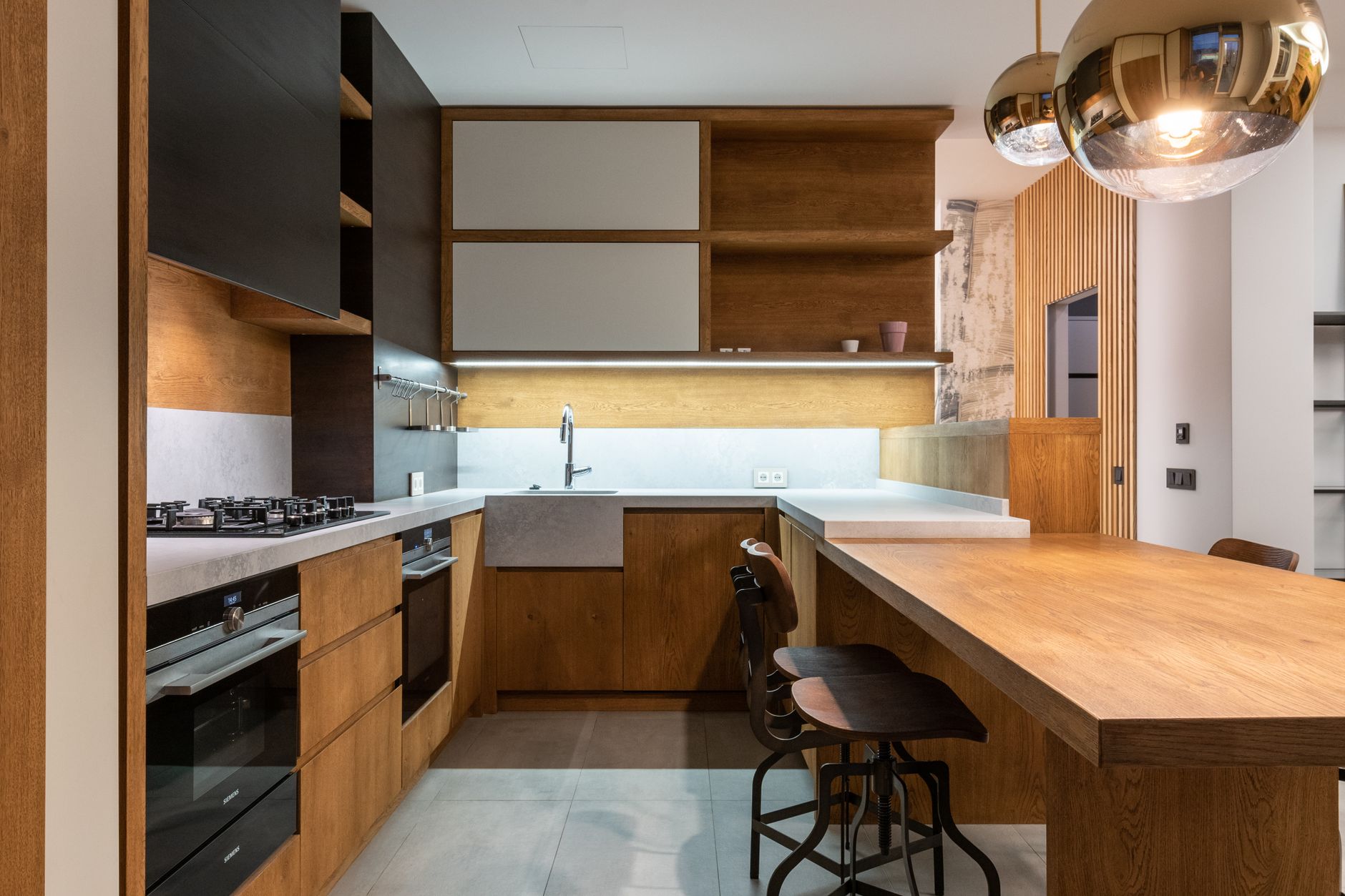 Small plug-in lamp casting warm light across a kitchen coffee station at dusk